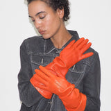 Person wearing orange gloves with a plain background