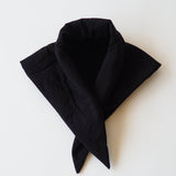 Black puffy scarf on white background