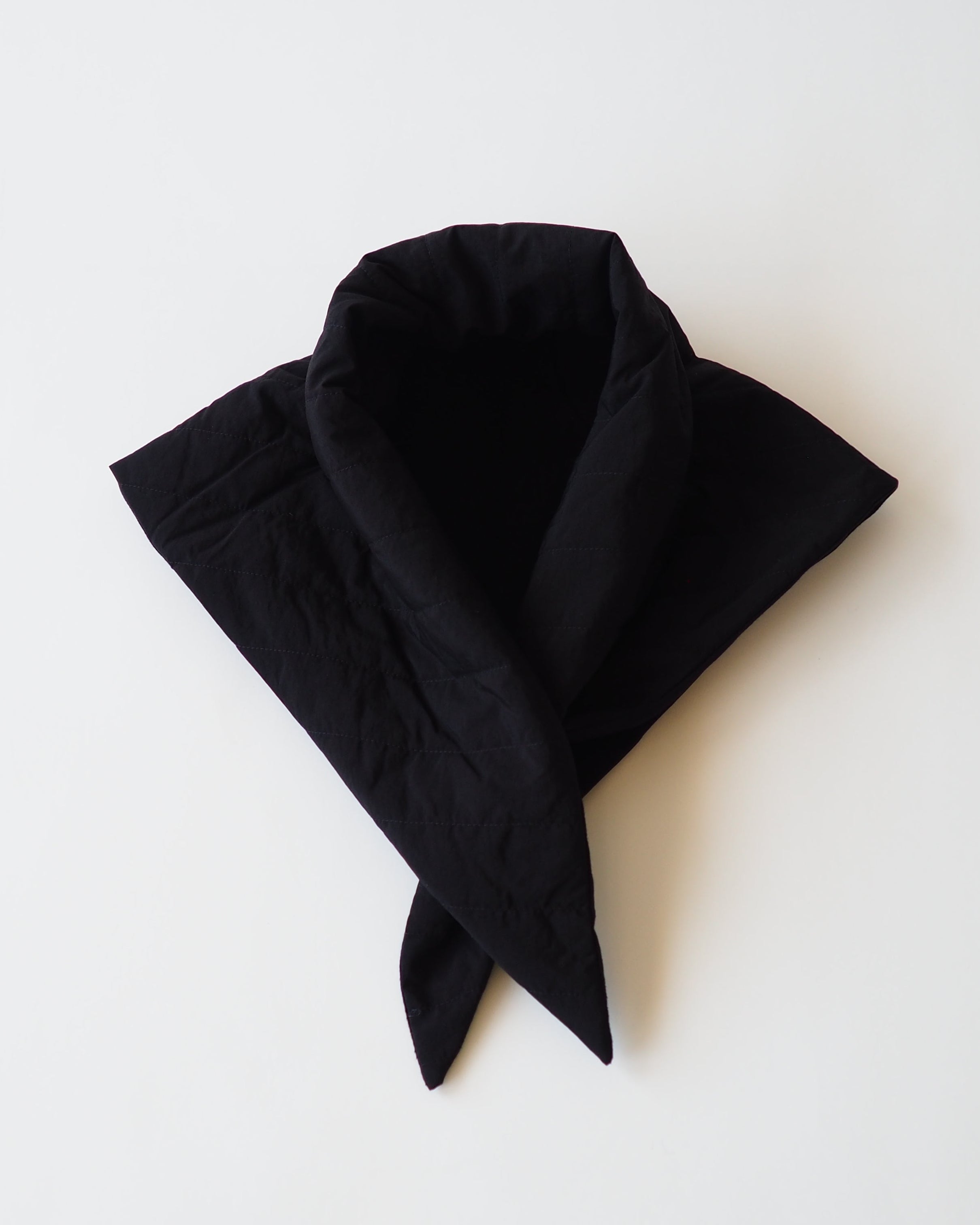 Black puffy scarf on white background